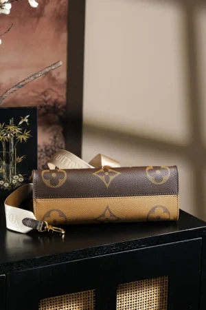 Louis Vuitton Chip Jumping Code Series shoulder bag featuring a stylish design with a brown and tan color scheme, displayed on a black surface with decorative background elements.