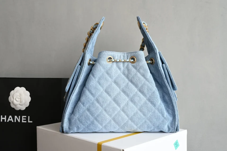 Chanel Drawstring Bucket Bag blue quilted denim gold chain leather trim luxury handbag