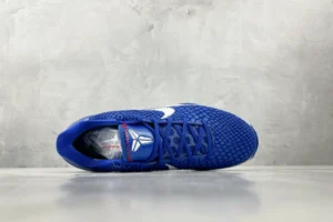 Nike Zoom Kobe 6 Protro “Dodge” sneaker in blue with white logo, top view on a gray surface.