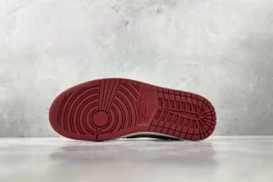 Nike Air Jordan 1 High OG red outsole rubber sneakers showing detailed tread pattern and Nike logo embossing