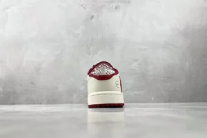 Nike Air Jordan 1 Low OG Sail Team Red white leather sneakers rear view with embroidered wings logo