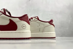 Nike Air Jordan 1 Low Travis Scott sail red leather sneakers with distinct backward Swoosh design and lightning bolt logo