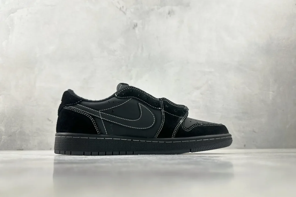 Nike Jordan 1 Low OG black colorway leather and suede sneakers with white stitching detailing