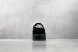 Nike Jordan 1 Retro Low OG 553558-016 black colorway suede material sneaker viewed from heel with Air Jordan logo