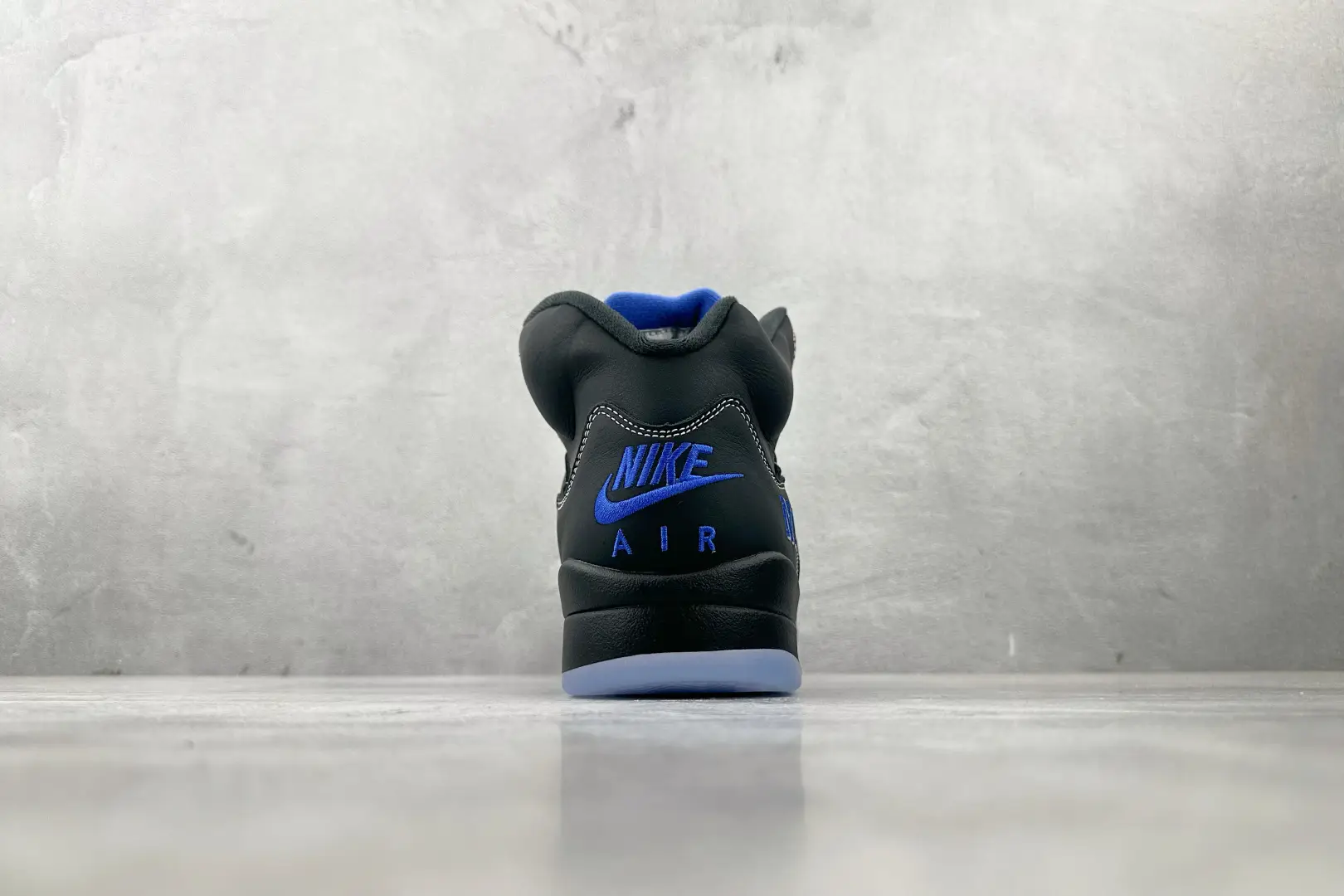 Nike Air Jordan 5 Retro black royal blue leather sneakers with blue embroidered logo and ice sole