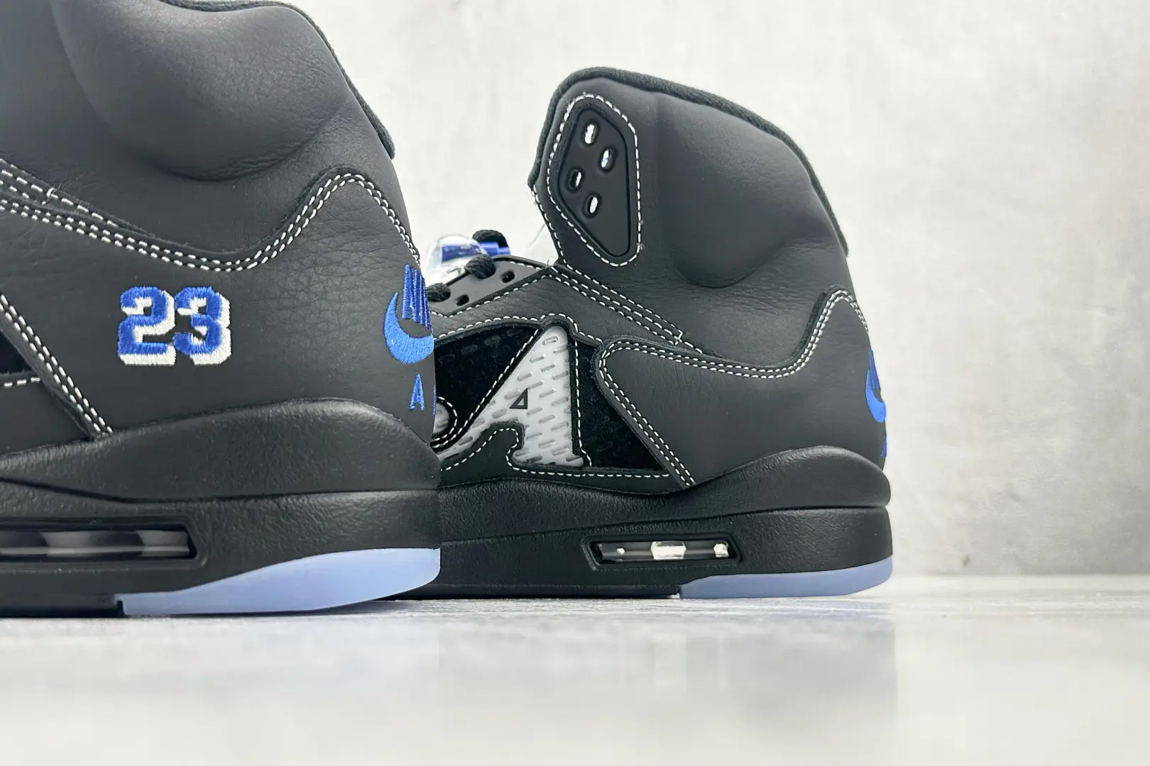 Nike Air Jordan 5 Retro Black Blue White leather sneakers with embroidered 23 detail and translucent sole