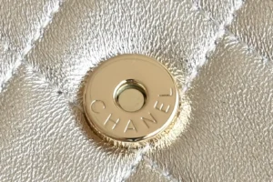 Chanel bag gold leather quilted pattern with gold snap button clasp detail