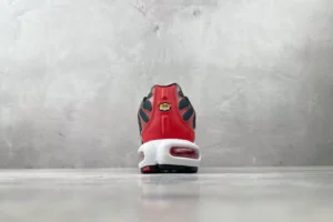 Nike Air Max Plus TN red black white synthetic leather sneakers back view on gray floor