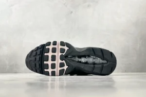 Nike Air Max 95 Grey Pink shoe sole with textured black rubber and pink accents, showcasing its design and construction.