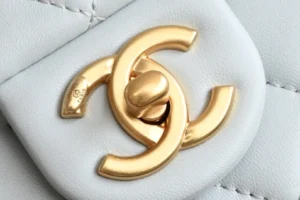 Chanel accessory gold-tone metal logo clasp on white quilted leather