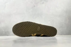 Onitsuka Tiger Mexico 66 black and yellow leather sneakers with textured rubber sole visible from bottom view