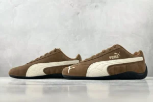 Puma Roma brown white colorway suede sneakers with black rubber sole and white Puma logo on side and toe