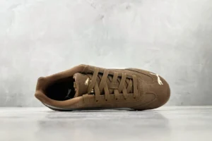 Puma Roma brown colorway suede sneakers with white logo detailing and lace-up design