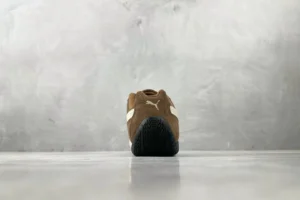 Puma Suede Classic brown white suede sneakers with black rubber sole viewed from heel