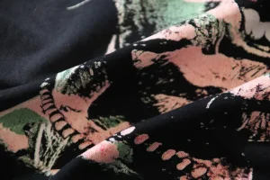 Repsgoat fabric textile black green pink cotton material with abstract pattern design close-up