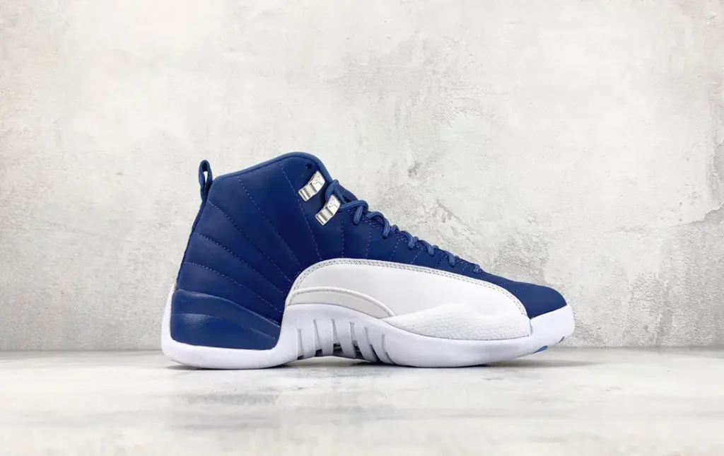 Air Jordan 12 Retro Indigo blue white leather sneakers with metal eyelets and rubber sole