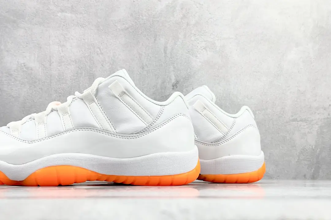 Nike Air Jordan 11 Low white orange colorway leather sneakers with bright orange sole rubber outsole