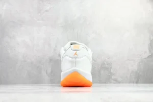 Nike Air Jordan 11 Low white orange leather sneakers with gum sole and Jumpman logo