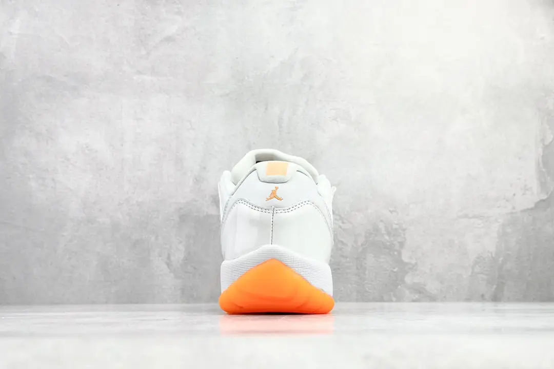 Nike Air Jordan 11 Low white orange leather sneakers with gum sole and Jumpman logo