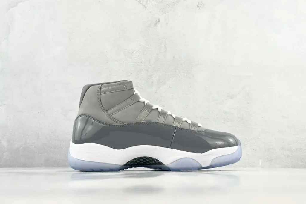 Nike Air Jordan 11 Cool Grey colorway leather and patent leather sneakers with white laces and translucent sole