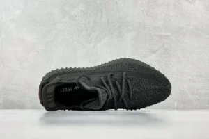 Adidas Yeezy Boost 350 V2 black Core knit sneakers with textured sole and signature red heel tab