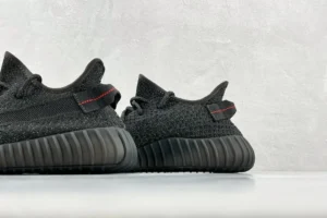 Adidas Yeezy Boost 350 V2 Black Red Primeknit sneakers with ribbed sole and red stitching detail
