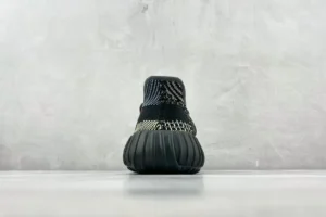 Adidas Yeezy Boost 350 V2 black white knit fabric sneakers with ribbed black sole viewed from the back