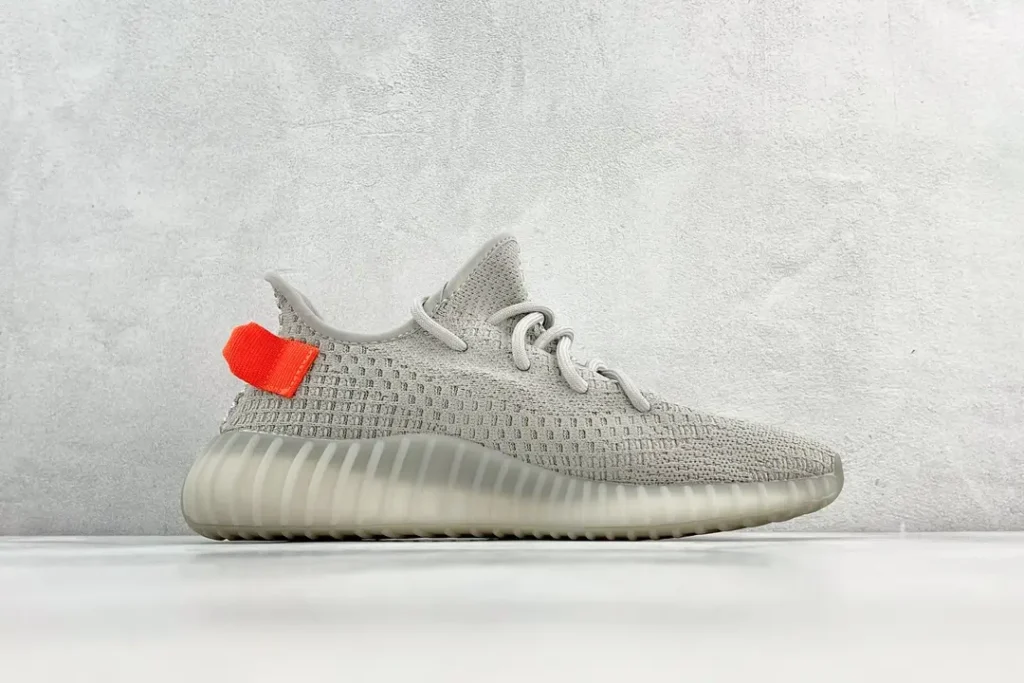 Adidas Yeezy Boost 350 V2 stone reflective knit sneakers with translucent rubber sole and orange heel tab