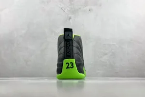 Nike Air Jordan 12 Retro black electric green leather sneakers with visible stitching and branded heel tab