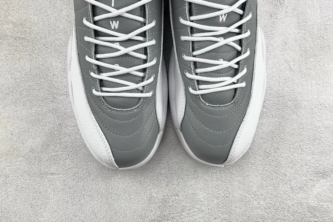 Air Jordan 12 Retro Cool Grey white and grey leather sneakers with detailed stitching and white laces