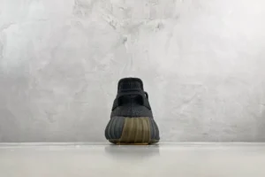 Adidas Yeezy Boost 350 V2 black and brown primeknit sneakers viewed from the back with textured sole