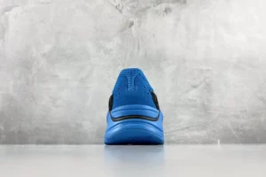 Adidas Yung-1 blue black synthetic mesh sneakers back view on gray background