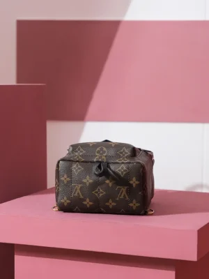 Palm Springs Mini backpack in Monogram canvas displayed on a pink pedestal, showcasing luxury design and craftsmanship.