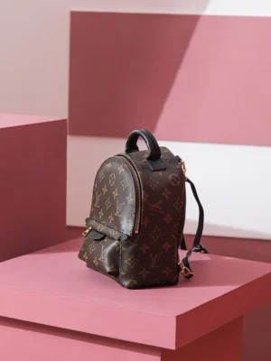 Palm Springs Mini backpack in Monogram canvas on pink display, showcasing luxury design and functionality.