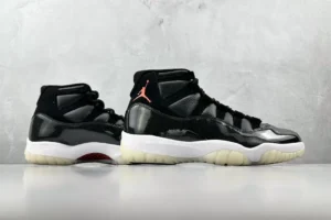 Air Jordan 11 Retro Jubilee black white red patent leather sneakers with translucent sole