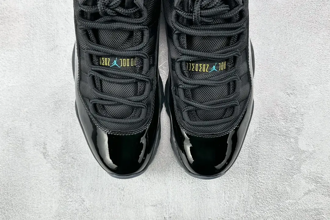 Nike Air Jordan 11 Retro Cap and Gown black patent leather sneakers with mesh upper and icy sole