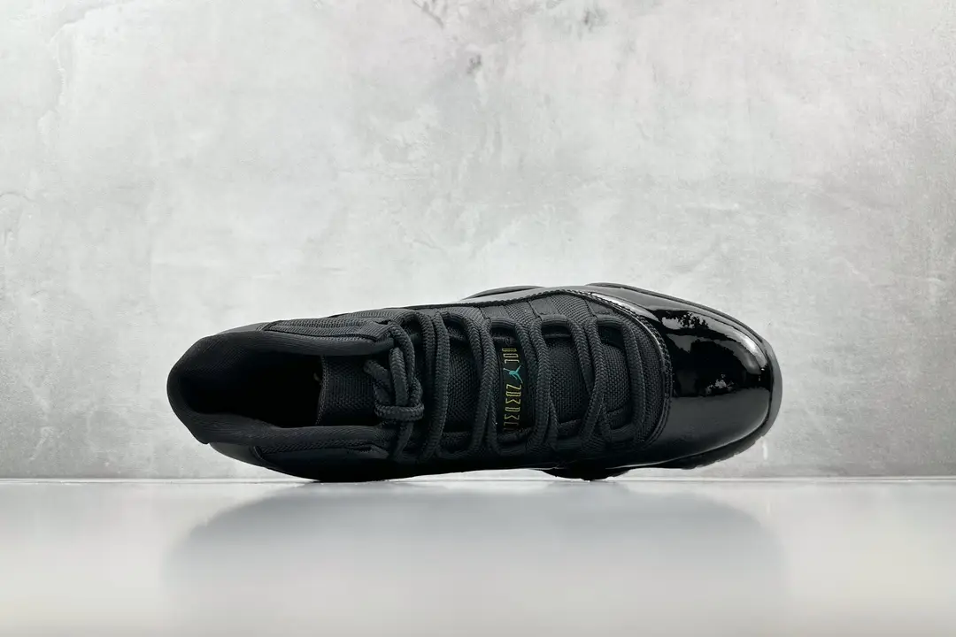 Nike Air Jordan 11 Retro black colorway patent leather sneakers with mesh upper and carbon fiber sole