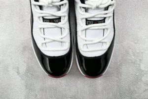 Nike Air Jordan 11 Concord white black patent leather sneakers with rounded toe and rope laces