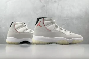 Nike Air Jordan 11 Retro Platinum Tint white grey black leather sneakers with red logo