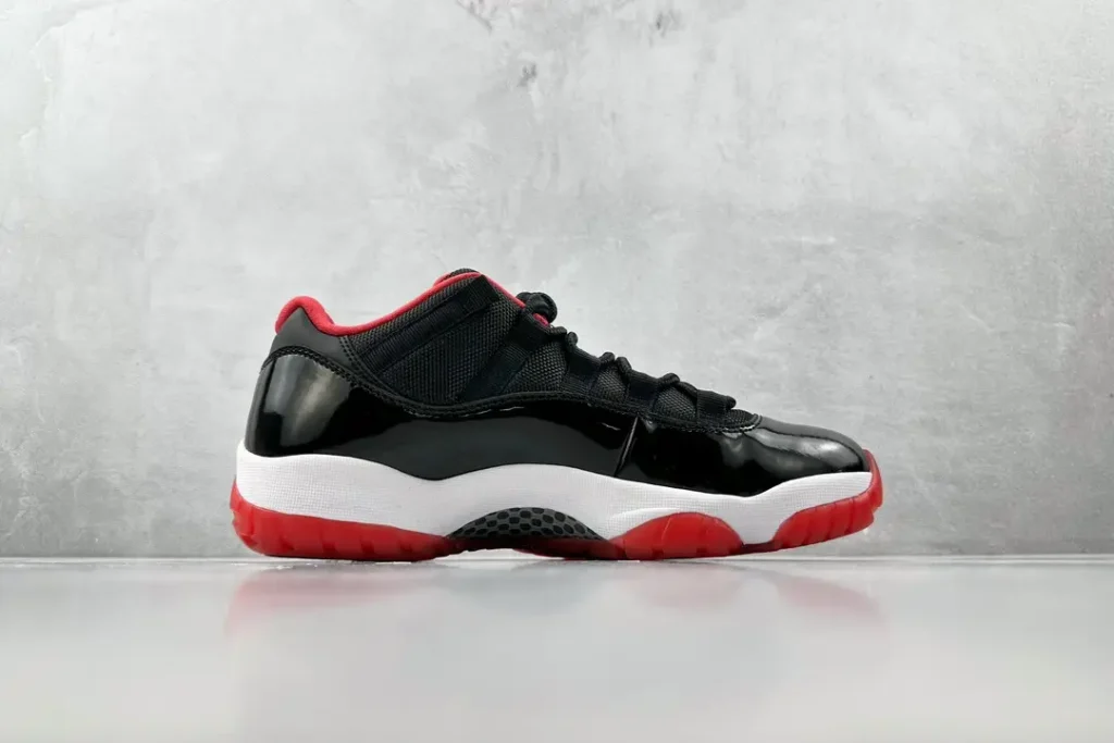Nike Air Jordan 11 Retro Bred black red white patent leather sneakers with mesh upper and rubber sole
