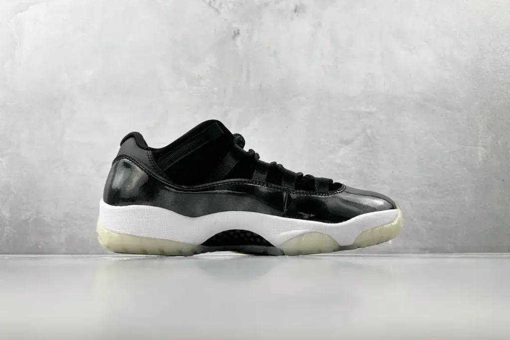 Air Jordan 11 Low black white patent leather sneakers with translucent sole and mesh details