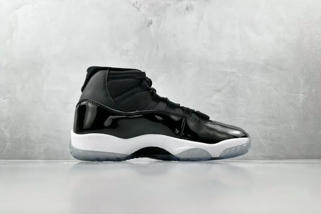 Nike Air Jordan 11 Retro black patent leather sneakers with white midsole and icy translucent outsole