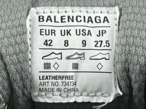 Balenciaga size label for Silver Grey 3XL Mesh Strap sneakers, displaying EUR, UK, USA, and JP sizes, with care instructions and item number 734734.
