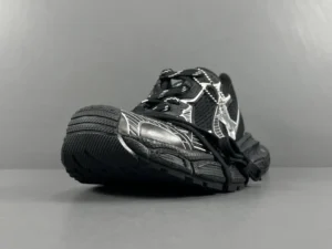 Black silver Balenciaga 3XL mesh strap sneaker with distinctive design and textured sole, showcased on a minimalistic background.