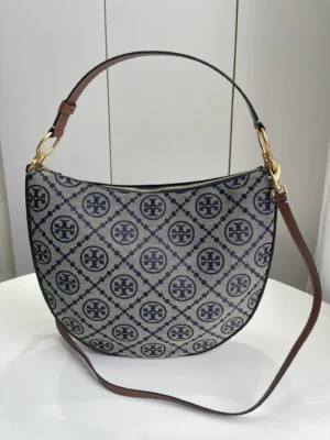Tory Burch Old Flower Series crescent bag replica featuring the TMonogram pattern, crafted with woven jacquard fabric and a detachable shoulder strap.