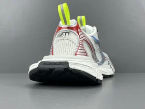 Balenciaga 3XL Mesh sneakers featuring a vibrant design with red and blue accents, visible size tag 41, and distinctive neon yellow pull tabs, set against a gray background.