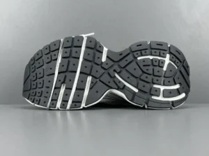 Balenciaga 3XL Mesh sneaker sole with textured black rubber and white accents, highlighting luxury footwear design.