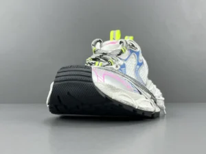 Balenciaga 3XL Mesh sneakers featuring a unique design with a textured sole, vibrant accents, and reflective details, showcased on a gray background.