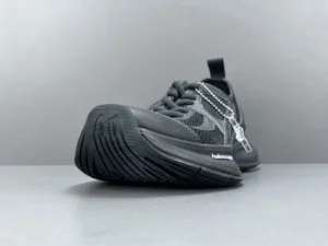 Black Balenciaga CIRCUIT print sneaker featuring a round-headed mesh design, showcasing breathable materials and a low-cut silhouette, emphasizing its shock-absorbing sole.