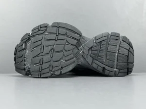 Black rubber outsole of Balenciaga Parisian Stapler shoes showcasing tread design and texture, emphasizing luxury sneaker features.